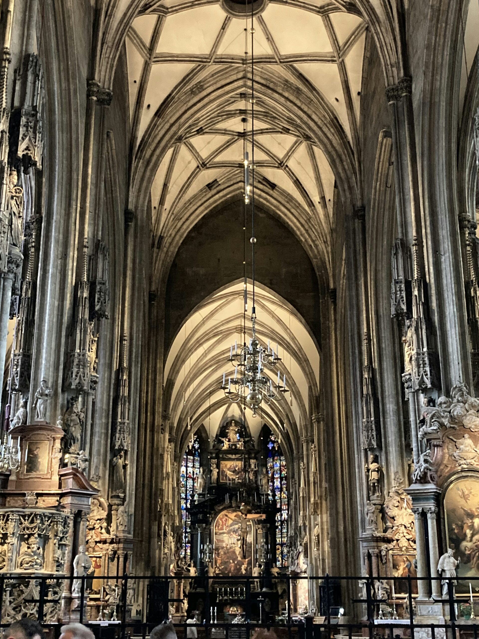 a large cathedral with a clock hanging from the ceiling