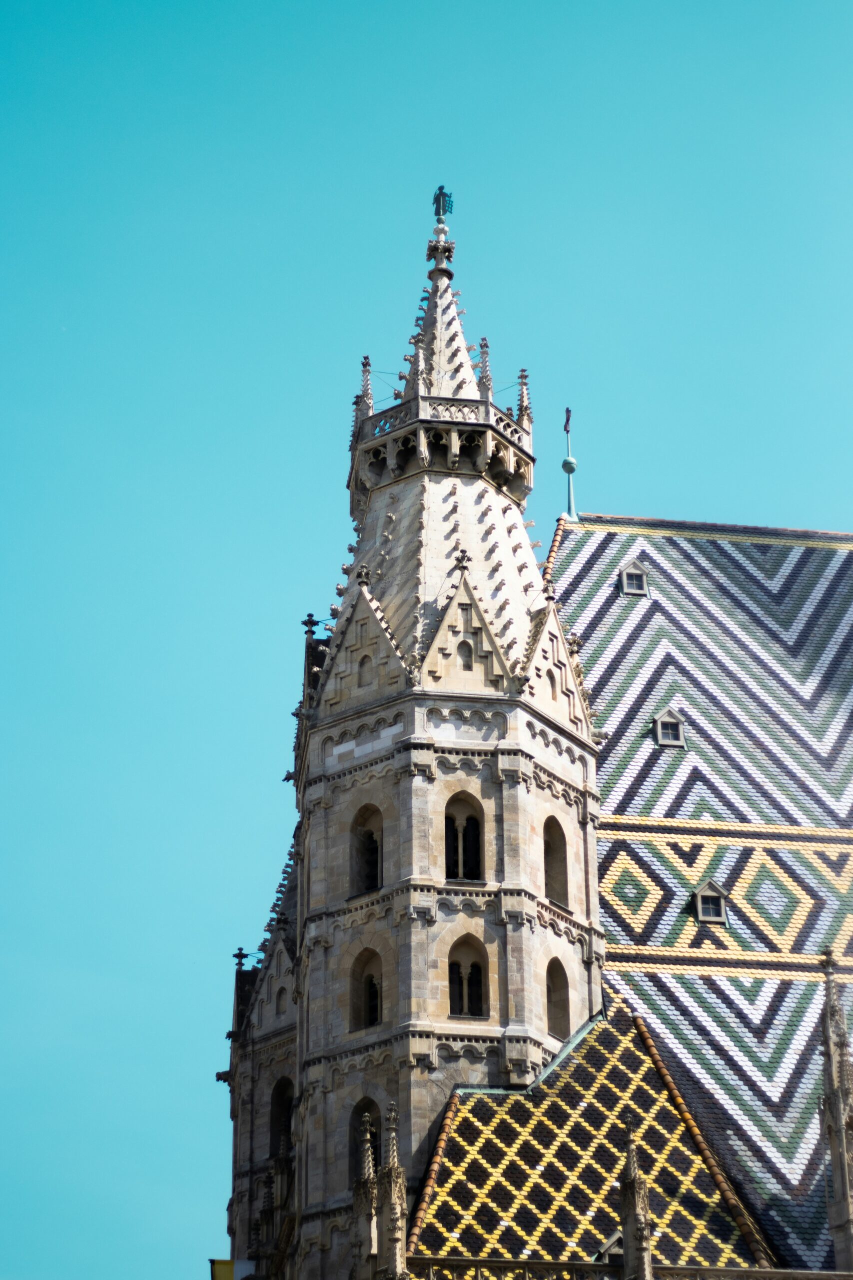 A tall, ornate church steeple against a blue sky.